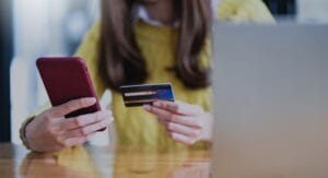 Young woman paying online by smartphone and credit card, Online shopping, Online banking.
