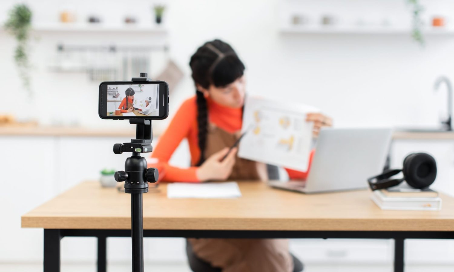 Caucasian woman influencer filming educational content with smartphone