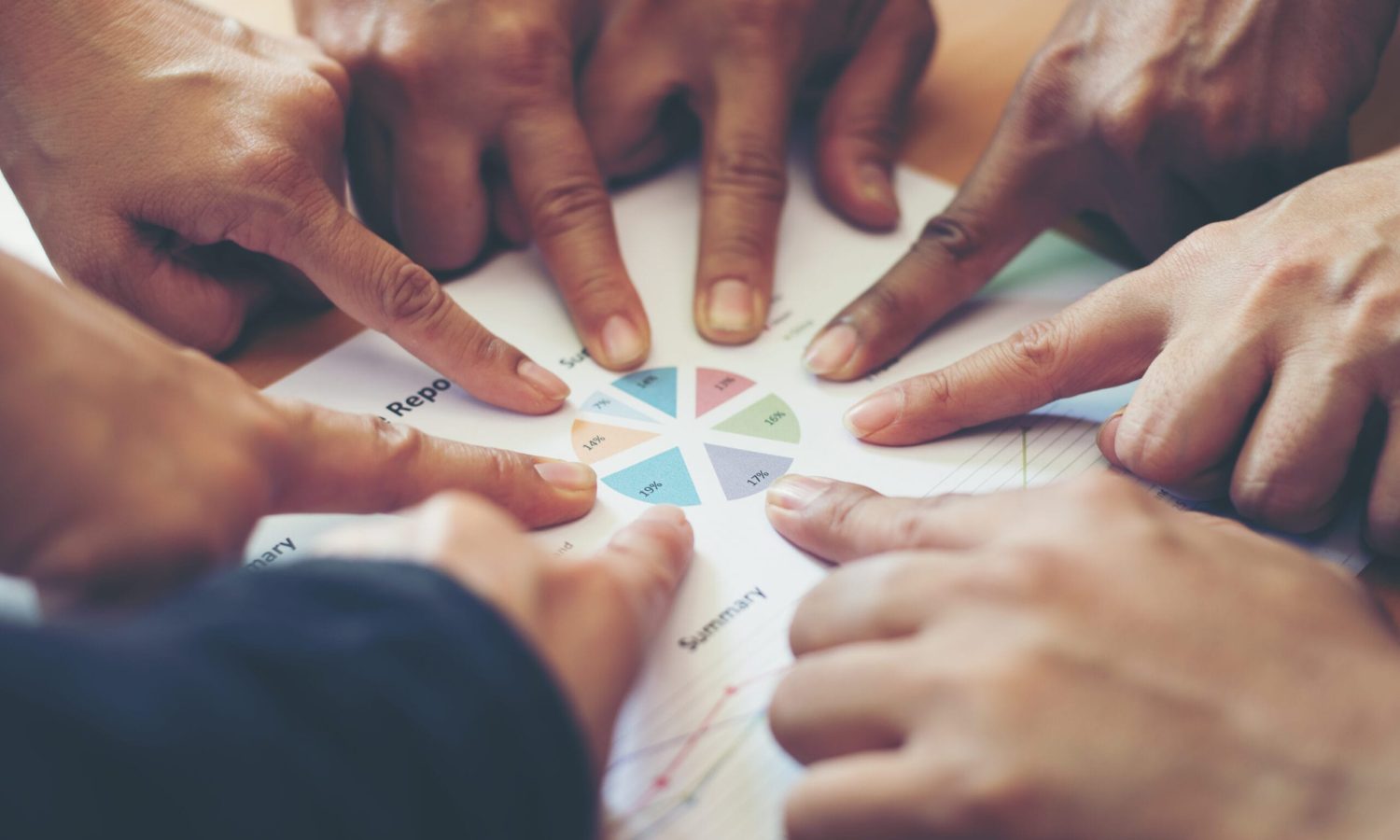 Group of business partners discussing ideas analysis and planning work in office.
