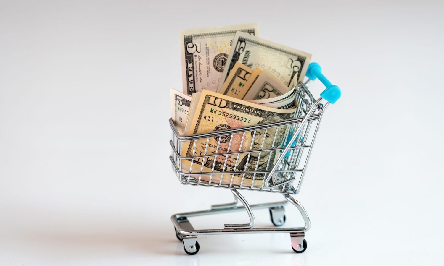 shopping cart full of money, business, finance, economy concept