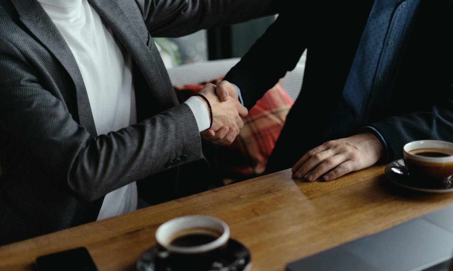 Young business partners shaking hands after agreement. Greeting concept. A successful deal